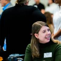 Guests sitting at a table talking.